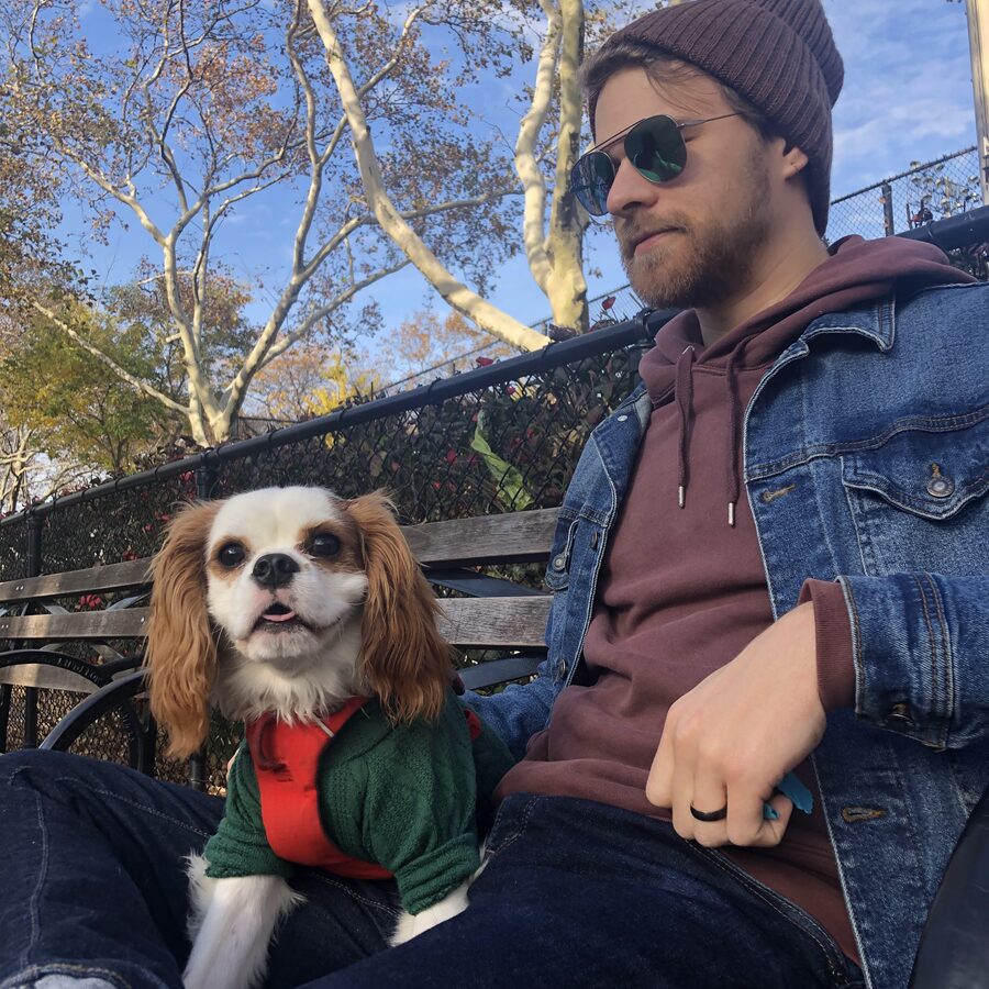 Me on a park bench in New York with one of our Cavaliers